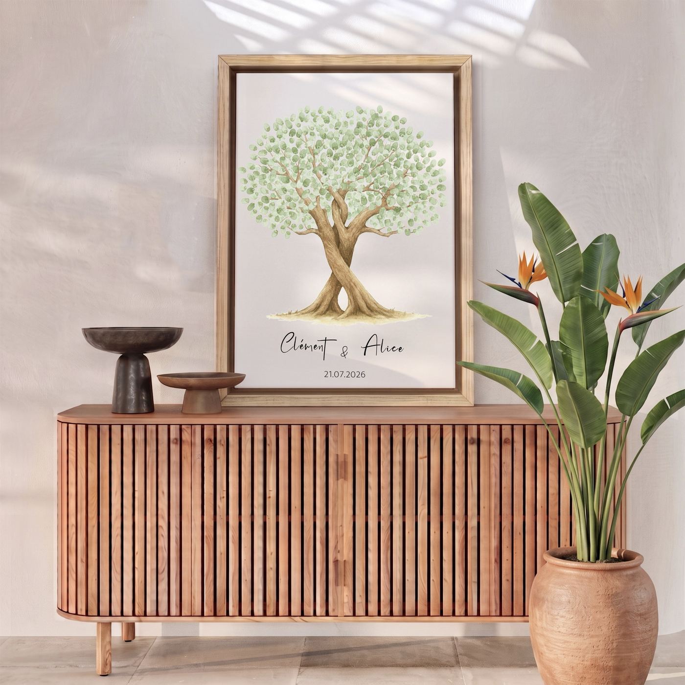 A framed green fingerprint tree standing on a sideboard in a sunlit hallway